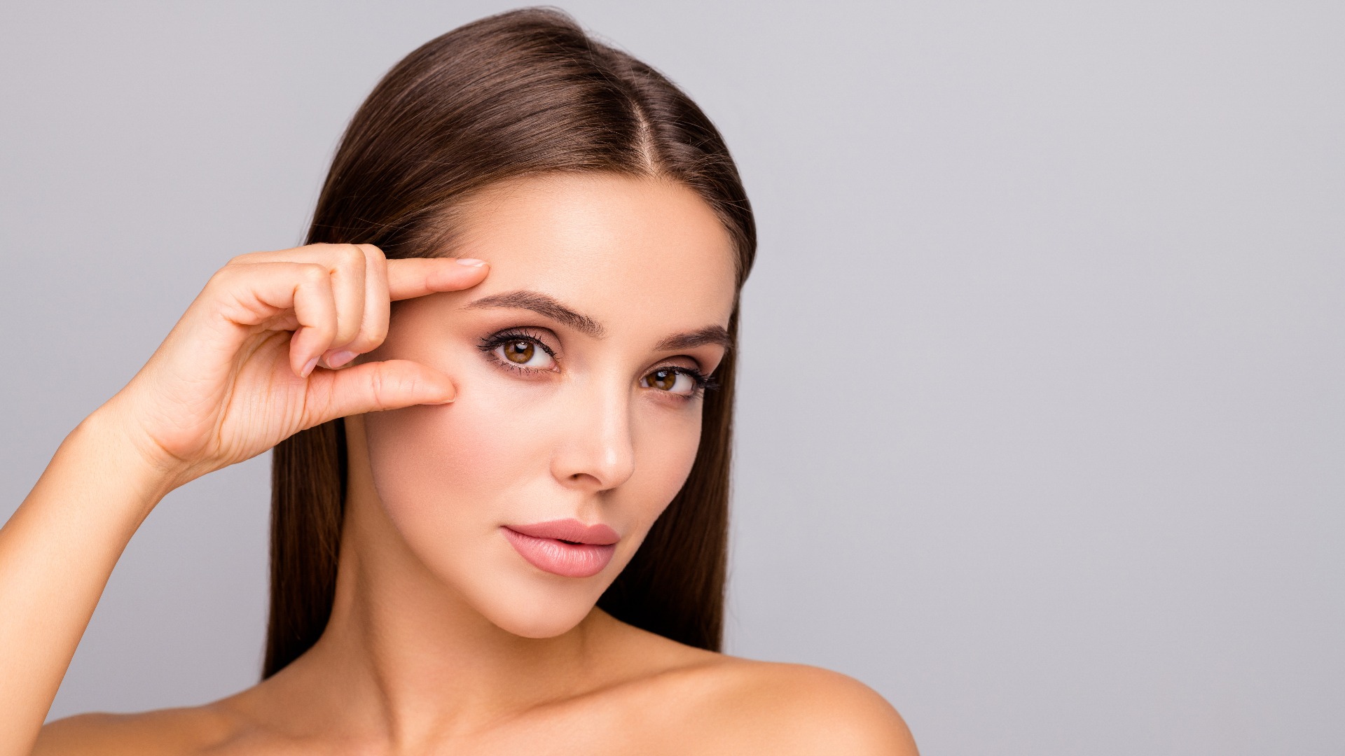 Closeup photo of beautiful lady nude naked shoulders plump shape lips tempting appearance fingers check eyebrow eye line no wrinkles face isolated grey color background